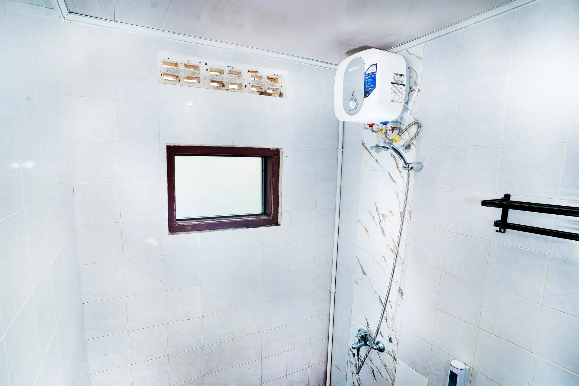 Bathroom with water heater and window