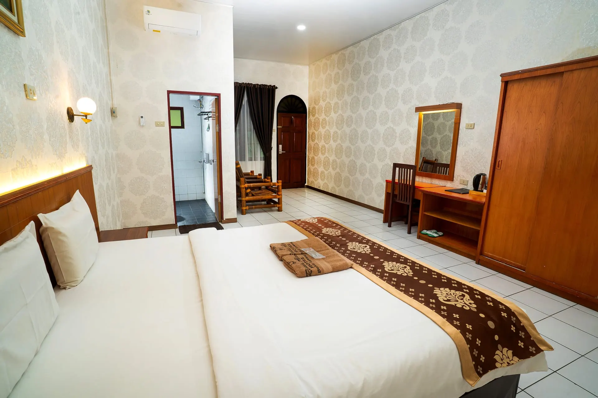 Superior Room bed with batik runner