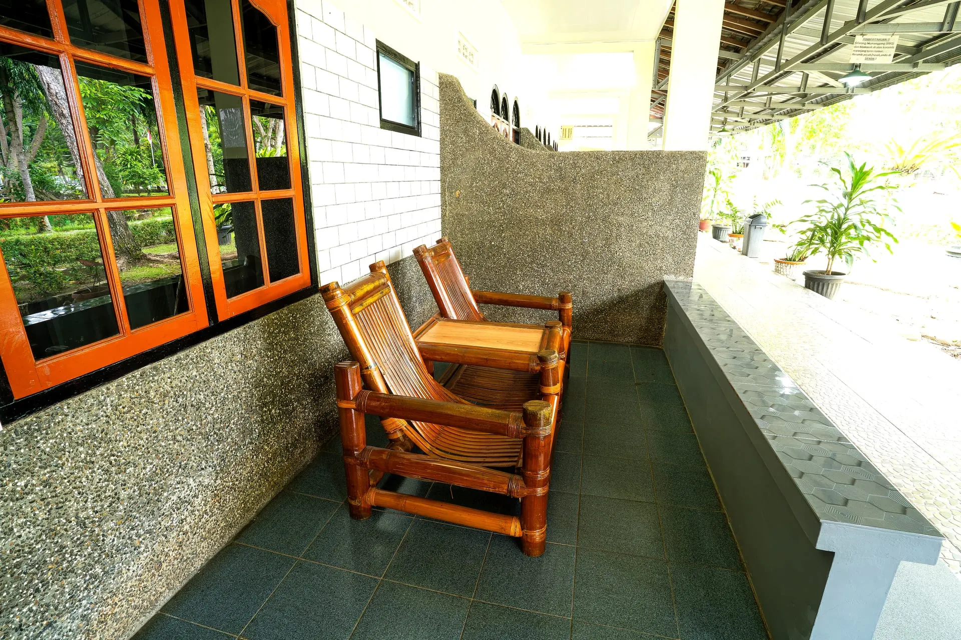 Room terrace with bamboo chairs facing the garden