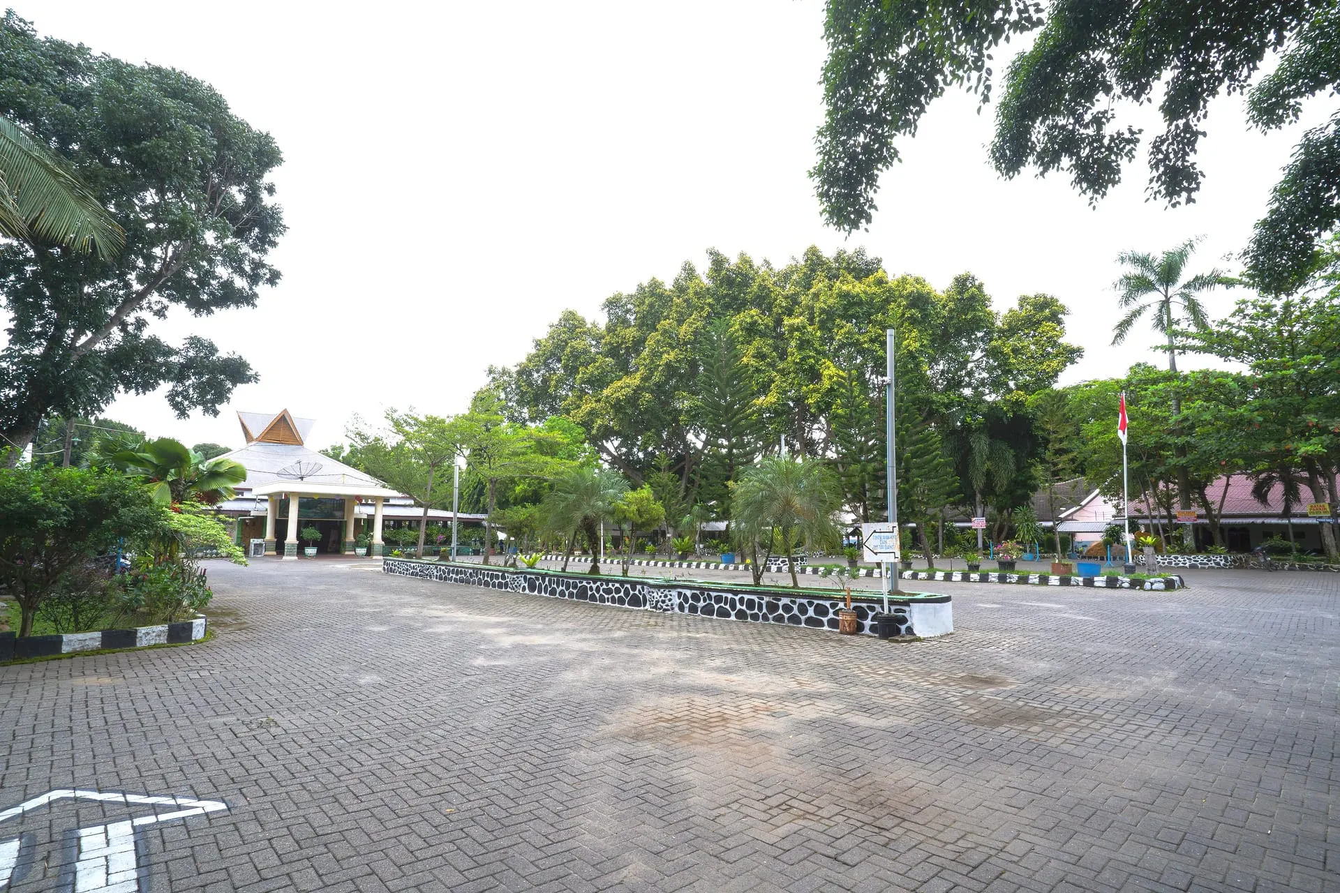 Hotel parking area shaded by trees