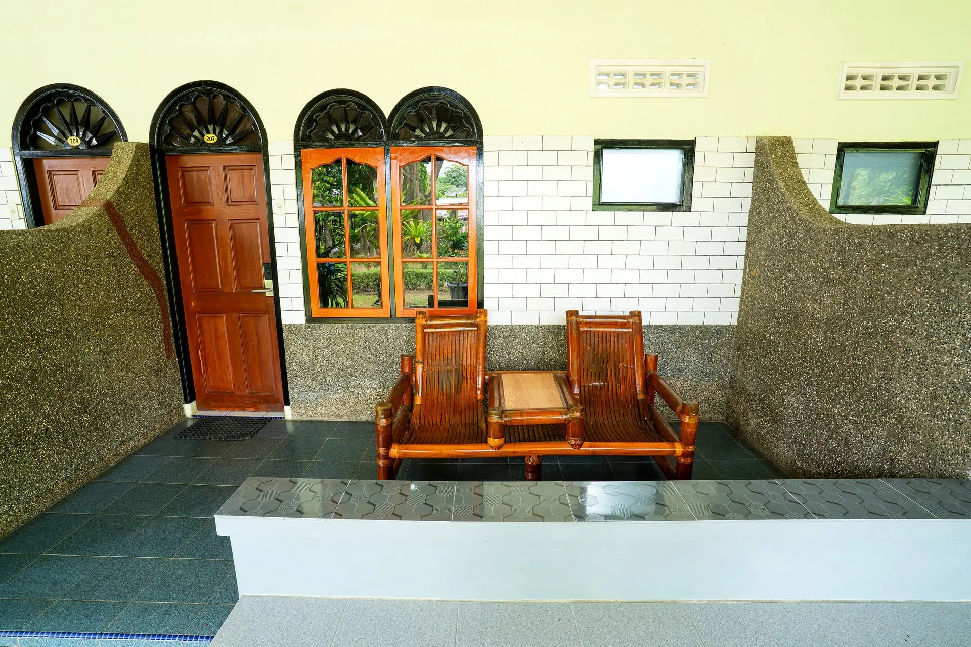 Row of room terraces with arched windows
