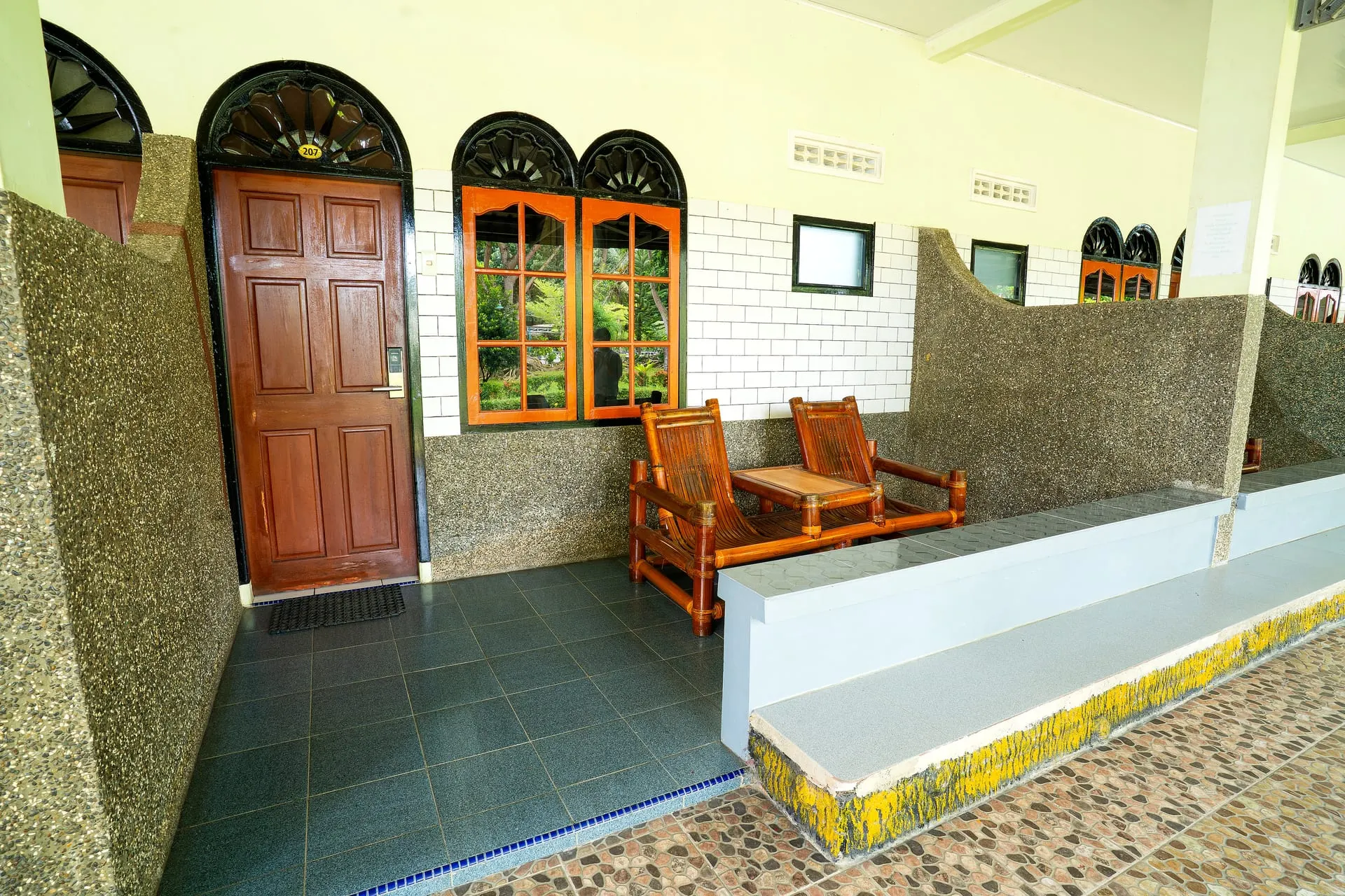 Room entrance and terrace with bamboo chairs