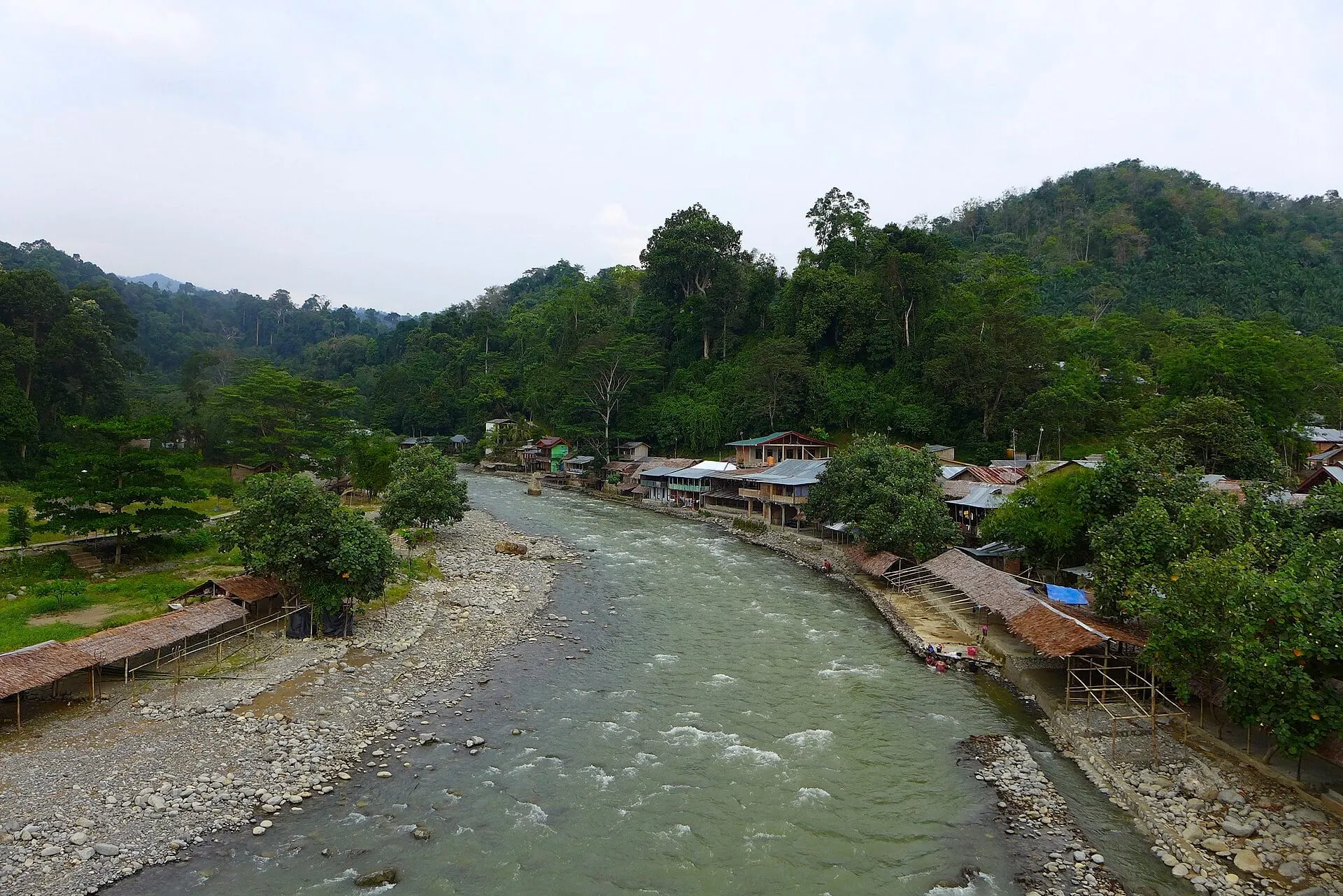 Bukit Lawang village along the Bohorok River, surrounded by forested hills