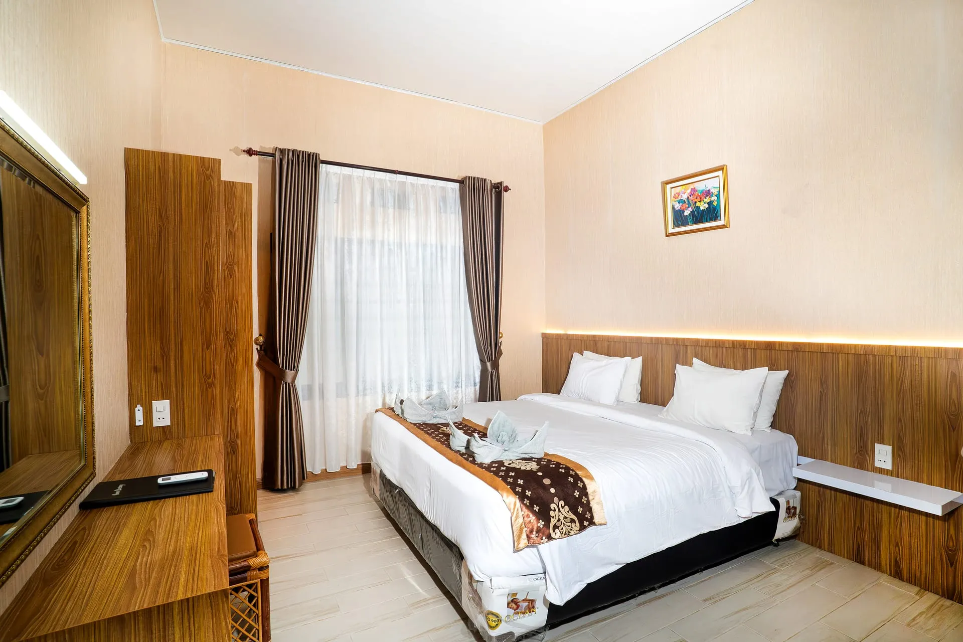 Deluxe Room with a large bed and wood-panelled wall